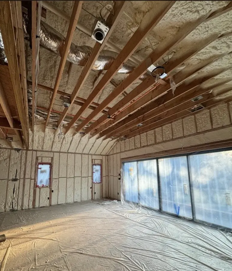 Interior walls and ceiling insulated with spray foam during new construction in Bryan
